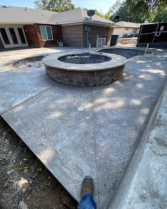 Circular pool feature area with finished concrete edge
