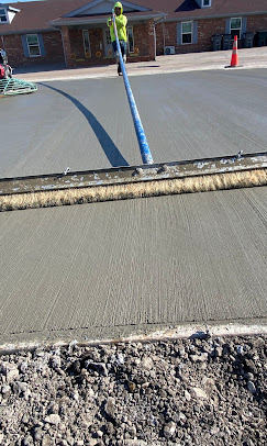 Fresh broom-finished concrete street pour with screed bar